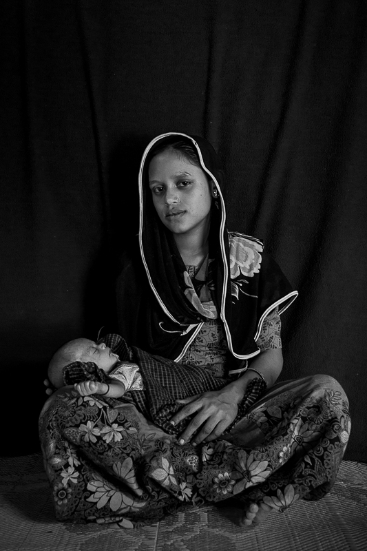 Rohingya mother Torojimaji from Keripryang, Myanmar with her 22 day old girl Rubina. She gave birth in the Kutupalong Rohingya refugee camp, Cox's Bazar.